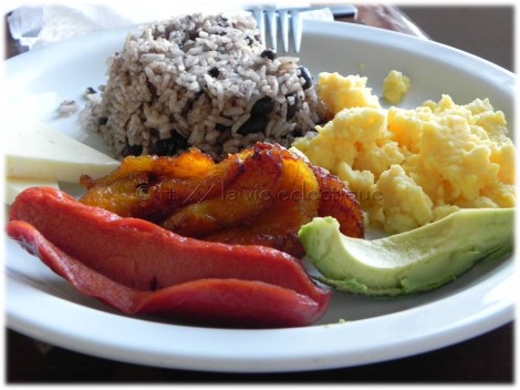 Typical breakfast = rice & beans, eggs, sausage (hot dog), plaintains, avocado.